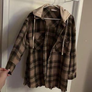 brown beige and black flannel with a cream colored hood and frayed at the bottom